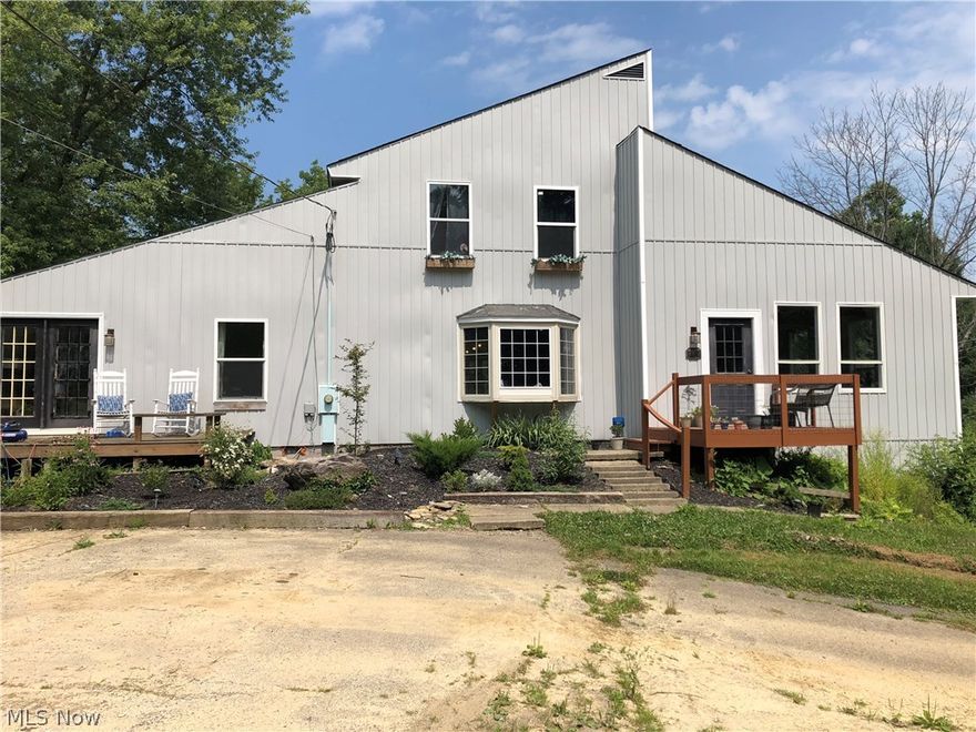 42 acres of extremely private living at this home that sits back nearly a 1/4 mile from the road! The recently renovated kitchen features amazing onyx counter tops on a massive island perfect for gathering. The great room features a large fireplace & vaulted  ceiling with a beautiful view of the stocked one acre pond! The formal dining room provides another beautiful view and access to the main deck overlooking the pond. The main floor holds two spacious bedrooms, one with a private deck and entrance. Upstairs you will find a loft overlooking the great room and two additional bedrooms. The current master bedroom has a private balcony deck that overlooks the pond and private woods. Updates include new siding, furnace with heat pump and A/C unit, and the pond filtration system. The property features a 30' x 50' garden with grape vines, blackberries, apple trees, pear trees, a strawberry patch, a partially fenced yard, trails, access to the Ashtabula River and plenty of wildlife. Catch th