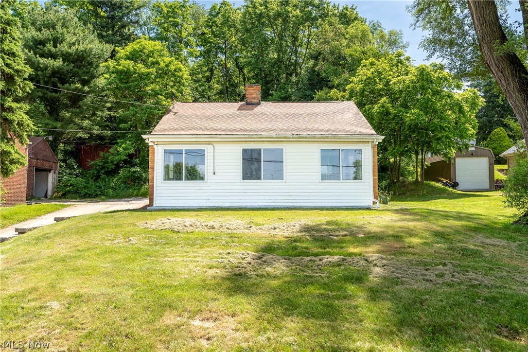 Welcome home to this spacious 4 bed/1.5 bath colonial on 0.5 acres located in North Canton! Enter into the 3 season room with newer windows and beautiful wood accent ceiling - a perfect spot for morning coffee or relaxing evening. The cozy living room is warm and inviting with a wood burning fireplace and hardwood floor. Large eat-in kitchen comes fully applianced with lots of cabinet and counter space. The full bathroom on the main level has an oversized countertop/vanity and shower/tub combo. There is additional flex space on first floor (currently being used as dining room) with deep closet for storage. First floor bedroom finishes off the main level. Upstairs is a massive primary bedroom vaulted ceilings, adorable built in shelving, window seating, dual closets and access to your own private deck over looking the tree-lined backyard. The second level also has two additional bedrooms and a half bathroom. The basement has been professionally waterproofed (Garrett's Waterproofing - 2022) and is wide open for buyer's finishing desires. There is an attached garage with additional garage/two level shed/storage. Conveniently located close to shops, restaurants, and highways.