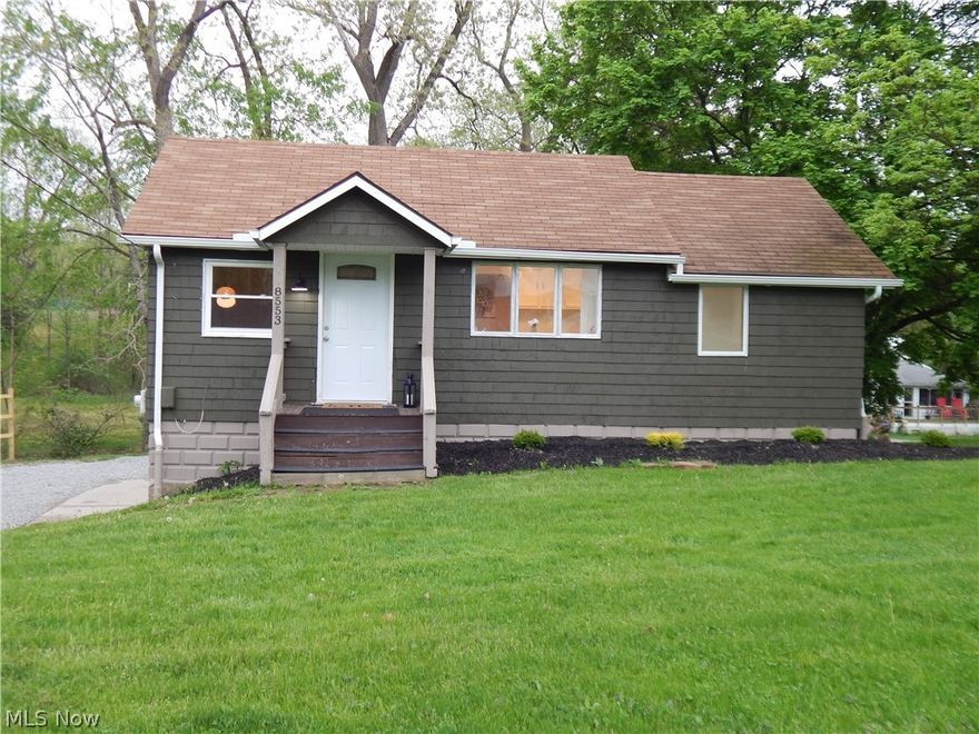 This cozy home is situated on a .77-acre parcel that is being sold along with the 3.53-acre parcel behind it (a total of 4.3 acres), which is ideally suited for a new build if desired. Or, just enjoy this cute updated home with new paint and flooring in one of Ohio's most desired zip codes. The kitchen has a new fridge, dishwasher, sink, base cabinets, and countertops. An all-new full bath has been installed on the main level as well. The larger two bedrooms and hallway have new carpet. The smaller bedroom/office has new LVT flooring. Downstairs features over 300 SF of additional walk-out living space with new carpet, paint and Wainscott just installed. Also new downstairs is the HWT and an additional room that had been converted to a laundry/storage area with a front-load washer/dryer combo and an all-new half bath. A small two-car garage is attached that will be suitable for most current model cars, some trucks may be too large. The land is a beautiful, open, plateau-like parcel ideal for hiking, gatherings, or an additional outbuilding if you like. So many possibilities in beautiful Broadview Heights! Schedule your showing today! The listing agent is related to the seller.