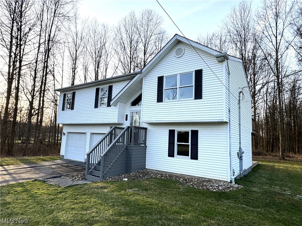 Welcome to this beautifully remodeled 3 bedroom, 1.5 bathroom home nestled on a partially wooded lot in Champion, OH. Every inch of this home has been meticulously renovated to provide modern comfort and style. As you step inside, you're greeted by the warmth of new flooring and freshly painted walls that create a welcoming ambiance throughout. The open-concept layout seamlessly connects the spacious eat-in kitchen to the main living area, making it ideal for entertaining guests. Equipped with all-new appliances, including a sleek stove, refrigerator, microwave, and dishwasher, the kitchen is the perfect set-up. And with halo lighting illuminating most rooms, every corner of this home shines with elegance. Step outside onto the double-tiered deck, accessible from both the dining room and family room, and take in the serene views of the beautiful lot surrounding the home. It's the perfect spot for outdoor dining, morning coffee, or simply unwinding after a long day. The comforts of this home extend beyond its walls, with a brand-new furnace, air conditioning system, and water system featuring reverse osmosis, ensuring your year-round comfort and convenience. Outside, the freshly landscaped yard adds to the home's curb appeal, creating a picturesque setting that you'll be proud to call your own. With its prime location in the Champion local school district and its impeccable renovations, this must-see home offers the perfect blend of modern living and natural beauty. Don't miss your chance to make it yours today.