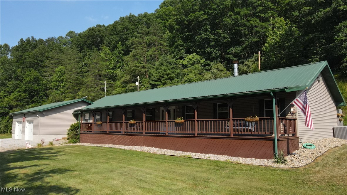 Welcome to this beautiful well maintained ranch-style residence nestled in a peaceful setting just two miles from a small town in Calhoun County, West Virginia. With 2,300 square feet of living space, this home perfectly blends rural tranquility with modern convenience. Featuring 4 bedrooms and 3 full bathrooms, this home has plenty of room for your growing family. Enjoy not one, but two comfortable living rooms, ideal for entertaining or relaxing with family. The large eat-in kitchen is a true centerpiece, complete with a bar area and cathedral ceilings that create an open, airy feel. Work from home with ease in the dedicated office area, and keep everything organized with a spacious laundry room that includes a laundry folding table, a large pantry, and a versatile crafting nook. Cozy up by the wood-burning fireplace during chilly evenings, and enjoy peace of mind with two hot water tanks and a brand new HVAC system. Step outside to take in the serene surroundings from your 65-foot covered front porch or the equally expansive 65-foot back deck—ideal for gatherings or simply relaxing in tranquility. Animal lovers will appreciate the attached dog kennel with doggie door, a chicken coop, and even a landscaped Koi pond that adds a touch of charm. A newly leveled area awaits your dream pool. The attached 3-car garage with a workshop provides protection for your vehicles, UTVS and tools. The property is thoughtfully designed for comfort, creativity, and self-sufficiency. If you’ve been searching for a private retreat with space, comfort, and character, this country gem is ready to welcome you home.