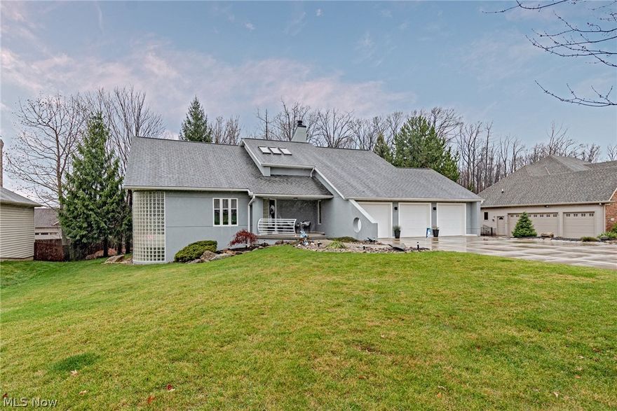 Fall in love with this elegant contemporary colonial in the heart of North Royalton! This delightful home provides over 2,700 square feet of living space plus a fully finished lower level! It is just waiting for a new owner! As you step inside, you will immediately appreciate the soaring ceilings and large windows that greet you in the living room. The dining room is open to the living room, and features large windows and a gorgeous custom light fixture. You will love the eat-in kitchen, which includes all appliances, a breakfast bar, white cabinetry and glass tile backsplash. Off of the kitchen, there is a cozy family room with a fireplace and deck access. A half bathroom and a convenient laundry room with a custom millwork washtub complete the first floor. Upstairs, you will find four bedrooms and two bathrooms, including the master suite. The master suite includes a spacious bedroom, a lovely en-suite bath with a tub, a step in shower, and a vanity with two sinks, plus, there is a v