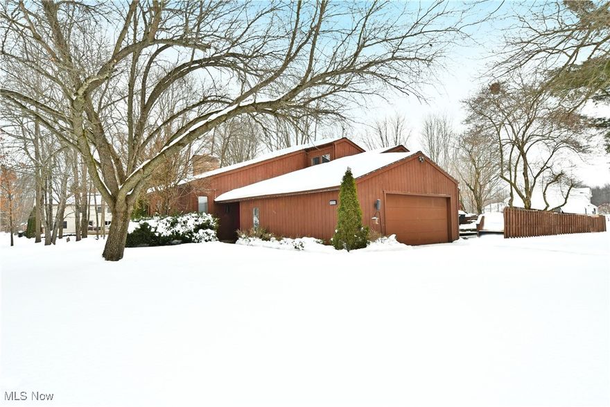 Looking for something a little different? Plenty of style, an open layout and an impressive amount of natural light? Hurry in, your dream home is ready! Welcome to the elegantly appointed and artfully exciting offerings of this hot-to-market Liberty Township estate. Sat off the road on a prominent corner lot, you’ll enjoy plenty of natural privacy and shade filled summers as tall trees cast an earthy veil above this stained wood sided beauty. A surrounding rear privacy fence encompasses a large storage shed and raised side patio for easy entertaining. Meanwhile, the sunken formal entryway leads you inside to find matching dropped foyer extending into the main hall. Revel in the must-see living room nearby where a towering brick mantle brings an inset fireplace, all while sunshine warms the plush carpets below. Tall ceilings extend to find a fantastic loft overlook, accessed by both decadent spiral staircase or a traditional banister led set; making a perfect guest bedroom or lounge. Continuing from the living room, remarkable formal dining space shares like attributed while joining the accompanying kitchen and its deep stained cabinetry. A pair of stylish full bathrooms join the pair of spacious bedrooms to complete the floor along with additional closet space. Downstairs, central rec room availability wows with a rustic, wood trimmed wall. Nearby, an additional bedroom is currently configured as a studio while laundry and storage complete the floor.