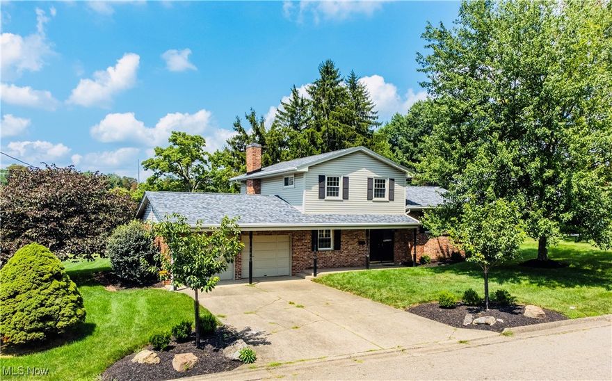 Welcome to this well-built, multi-level residence nestled on a premium corner parcel in the peaceful, well-established Hillview Estates neighborhood. Boasting 4 bedrooms and 2 1/2 baths, this home offers both timeless craftmanship and the opportunity to personalize every detail to your taste. Beneath the carpeting lie hardwood floors - ready for you to refinish and showcase. Relax in the cozy den, complete with a classic wood-burning fireplace - ideal for curling up with a good book or hosting family movie night. Just steps away from the laundry area, the generous cedar-lined closet offers abundant space for seasonal items, wardrobe overflow, or hobby storage. Direct interior access to the spacious two-car garage provides year-round convenience and additional storage. The home's location offers quick access to I-70 for a seamless drive to Wheeling, Pittsburgh or Columbus. Enjoy shopping and dining at the Ohio Valley Mall, downtown St. Clairsville's charming shops and restaurants and local favorites along National Road. Explore the beautiful National Road Bikeway just a stroll away from your doorstep. Contact your favorite Real Estate Professional today to set up a showing!