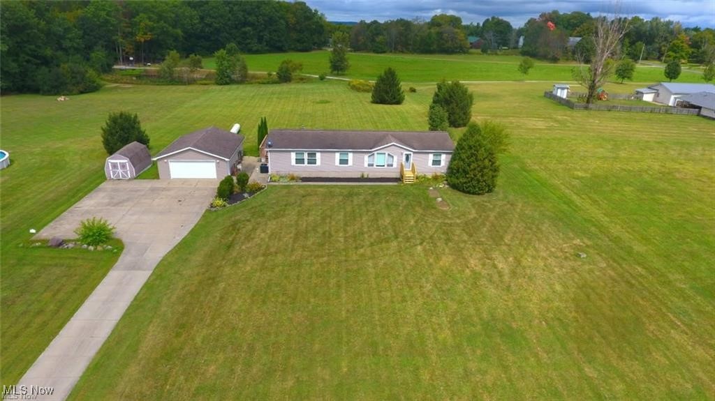 Welcome to Your Dream Retreat! This stunning manufactured home offers the perfect blend of comfort, style, and space. Nestled on a generous 2.2-acre lot, it features a long 250-foot concrete driveway leading to an oversized garage—ideal for vehicles, hobbies, or extra storage. Step out back to enjoy a sprawling 16x48 deck, perfect for entertaining or soaking in serene views of the large backyard. Inside, the open-concept layout includes a spacious eat-in kitchen with a center island, a cozy office nook, and direct access to the deck for seamless indoor-outdoor living. The mudroom doubles as a laundry area and connects to a full bath and the kitchen for added convenience. The den offers flexible space—use it as a relaxing lounge or convert it into a fourth bedroom to suit your needs. The glamorous master suite features glass double entry doors, a skylight above the jetted garden tub, a double vanity, and a walk-in closet.
Vaulted ceilings, a sparkling dining room chandelier, and a mix of carpet, laminate, and vinyl flooring add character throughout.
Additional highlights include:
• Electric fireplace (included)
• Buffet with six-chair dining set
• Nice-sized pantry
• Septic system cleaned two years ago
This property is move-in ready and packed with charm—whether you're hosting guests or enjoying quiet evenings under the stars, it’s a place to truly call home.