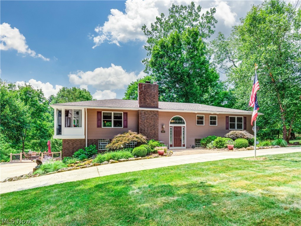 This 4 bedroom 3 bath home is nestled in a beautiful wooded setting, this property features a circular drive and boasts a total of 7 car garages. The open floor plan includes a cozy living room with a gas fireplace, a kitchen equipped with a breakfast bar, Granite countertops, stainless steel appliances, and a double oven. Adjacent to the kitchen is a spacious dining room and a sunroom perfect for year-round enjoyment. The master suite offers a private bath and a luxurious walk-in shower. The lower level is fully finished, providing flexible space, that can serve as a guest suite, family room, office, bedroom, bathroom, kitchenette, and laundry room. An expansive 56 x 24 outbuilding is heated, insulated, and plumbed for an air compressor, making it ideal for various uses. Recent improvements include a new washer, dryer and dishwasher in 2023, a deck and Nature Stone flooring in the 2-car attached garage in 2020, a furnace with 3 zones and an H2O tank in 2018, an air conditioner in 2017, a septic system in 2015, and windows, a roof, and a water softener in 2011. Call today to see.