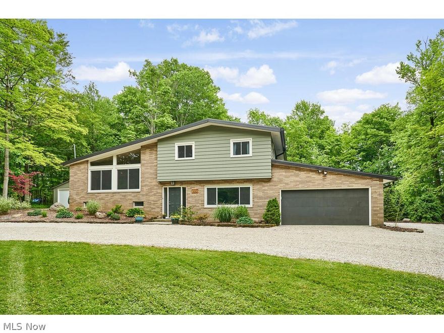 Fabulous and meticulously maintained 4 level split presents open living spaces and sweeping ceilings throughout   (Numerous updates and professional renovations)  Gorgeous hardwood floors on first 3 levels. State of the art kitchen boasts island/breakfast bar, expresso finish cabinetry, granite counters, SS appliances, huge walk-in pantry, and slider to newer patio. Spacious formal dining room with large picture window and new lighting. Wide staircase to vaulted great room with wood beamed ceiling, brick wb fireplace, wall of glass, and barn door to office/4th bedroom w/murphy bed, 15' ceiling, and wall of cabinets.  12' slider to all season sunroom addition highlights 2 skylights, vaulted wood ceiling, recessed tv, and access to platform deck and yard.  Owners suite w/floating headboard and new ensuite bath. Two additional sizable bedrooms and full bath complete the upper level.  Inviting family rm features dry bar w/refrig & wine cooler and gas fp. Notable highlights incl all new bat