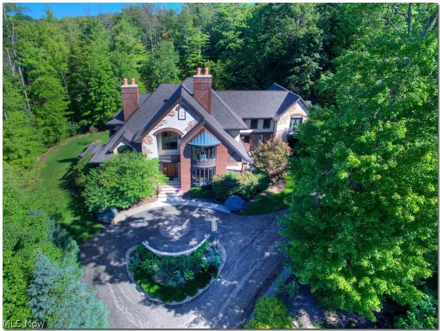 Elegant, Bespoke English Manor on 1.5 acres in prestigious “Canyon Lakes”! This amazing 2 story home reminiscent of a Shaker Heights home of yesteryear, offers today’s amenities and more. Amazing quality abounds, four fireplaces, spacious formal main rooms. Living room opens to veranda. Custom kitchen with Schrock Birch cabinetry, Viking gas cooktop and double ovens, commercial hood, 2 dishwashers, prep and main sink. “Bahia Blue” Sodalite (rare) counters, with breakfast bar and eating area. Kitchen opens to Gazeboed screened porch and deck. Library with coffered ceiling, fireplace and amazing built-ins and detail. Barrel vaulted foyer with crystal chandelier, marble floors and Mahogany entry door. Master suite on 2nd with balcony overlooking water feature in scenic, wooded yard. Bonus/media room, 27 x 20; ample bedrooms and closets! Fabulous lower level. Guest house framed with additional 2 car garage. Main house has attached 2 car but room for 3, with basement access. Award winning K