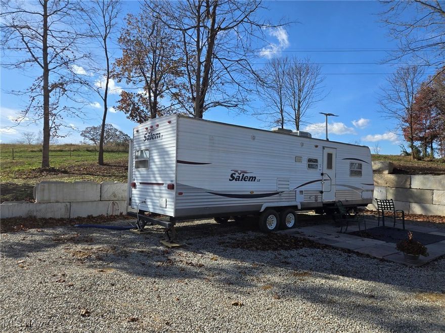 Escape to your own private retreat with a stunning three acre property boasting a panoramic view of the Muskingum River Valley. Enjoy morning coffee on your deck overlooking the valley and unwind in a camper with two slide outs and a cozy bunk area. With City water, a brand new septic system and a small storage building this secluded gem is a rare find. Just outside of Malta. Nat far from Jesse Owens State Park and The Wilds animal preserve.