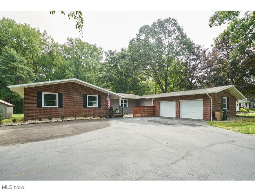 Welcome home to this completely updated sprawling Ranch situated on just under 1 acre, offering 4 beds, 2.5 baths w/2500 sq ft & approx. $240,000 in updates since 2022.  A bright foyer greets you upon entry, w/two expansive living spaces both offering a cozy fireplace. Solid wood interior doors, trim, and baseboards add an elegant touch, while crown molding enhances the living rooms, & dining space.  The kitchen has been entirely renovated, showcasing luxury vinyl plank floors that flow throughout the home, stunning cabinetry w/crown molding, & granite counters.  Each bedroom is generous in size w/favorable closet space. The expansive master has beautiful views along w/a completely gutted & tastefully updated bathroom. The guest bath has also been fully updated w/new floor, vanity & dual sinks. There is a calming screened-in back porch off the kitchen. This is a wonderful spot for you to enjoy outdoor relaxation w/serene parklike wooded views & an expansive deck. The extensive list of