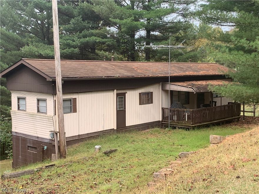 An ideal getaway-from-it-all place at beautiful and serene Piedmont Lake. The manufactured home on private property sits on a solid foundation nestled among mature pines a few doors from cul-de-sac at end of Skyline Drive. Pleasantly private, yet not isolated lot of more than half an acre. Well and septic system. Propane furnace and central air conditioning. Nice workshop in dry basement with lots of project and storage space. Close to the lake, where dock space is available. Comes with pontoon boat and trailer, golf cart, canoe &  ATV. Dock is included & will transfer to new owner.