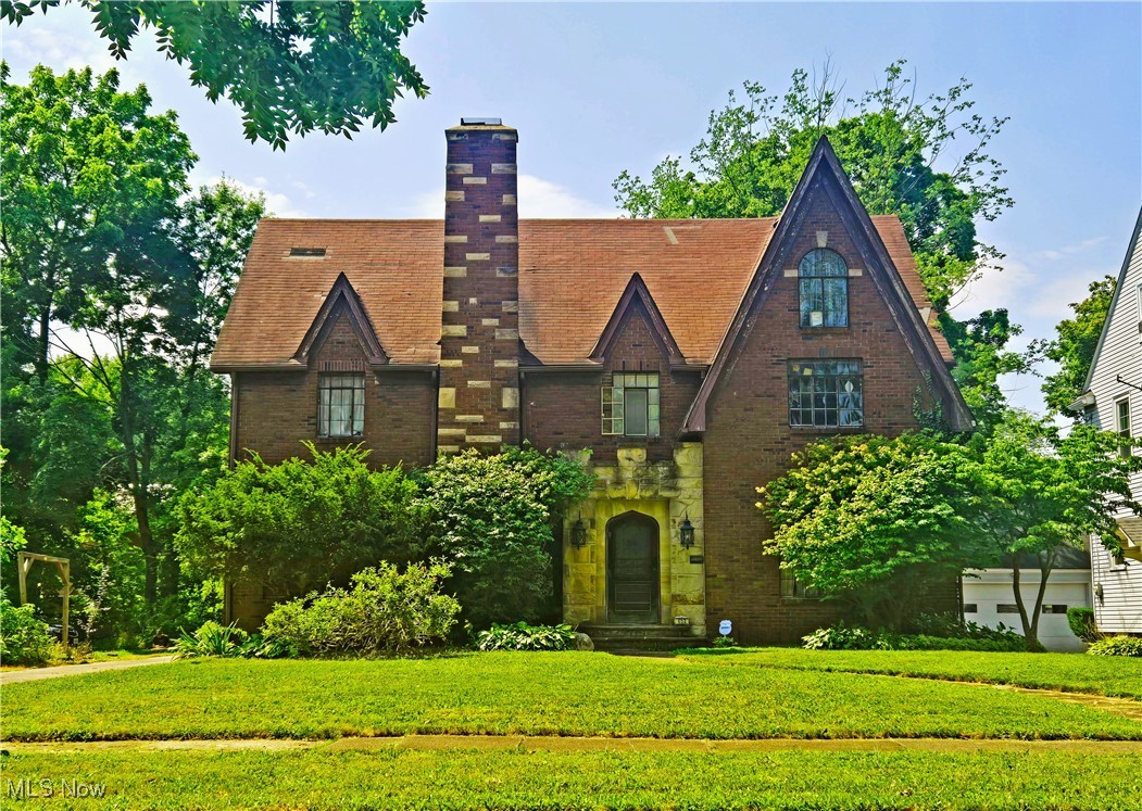 Beautiful spacious Akron brick Tudor home! This elegant, charming home boast nearly 2,500 sq/ft of living space. A lovely sun room at the back entry bringing in tons of natural light. Open grand staircase and hallway at front entry. Large kitchen waiting for your finishing touch. Living room, formal dining room, a first floor half bath, as well as bonus room off kitchen with built-ins. Plenty of storage in the full basement. Upstairs you'll find 4 spacious bedrooms and two full baths. Lots of lovely hardwood and charming crown molding throughout. This home has been well loved by the occupying owner who can no longer keep up with it, will need some rehab/TLC but is just waiting to be fully restored to its former beauty! To be sold AS IS, please see disclosures. Owner still occupies property, interior photos/virtual tours available by request. Perfect for an investor, or someone who loves these incredible old Akron homes! A lot to see, book your tour today!