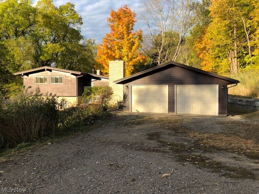 Beautiful Wooded 2.2 Acre homesite within a quick walk to Lake Erie!  This large split-level features recently finished hardwood floors, 4 bedrooms, 3 updated Full baths!  1st Floor and 2nd floor Master Bedrooms each with private baths! 1st floor Master has private entrance and rear deck access and could be in-law suite or home office!  Large dining room as well as eat in kitchen;  Economical hot water baseboard heating with Mini/split central air system!  Newer windows;  Newer Hot water tank;  Metal roof installed 6 years ago;  Multi-level decking;  shed;  large drive with ample parking;  Koi pond!