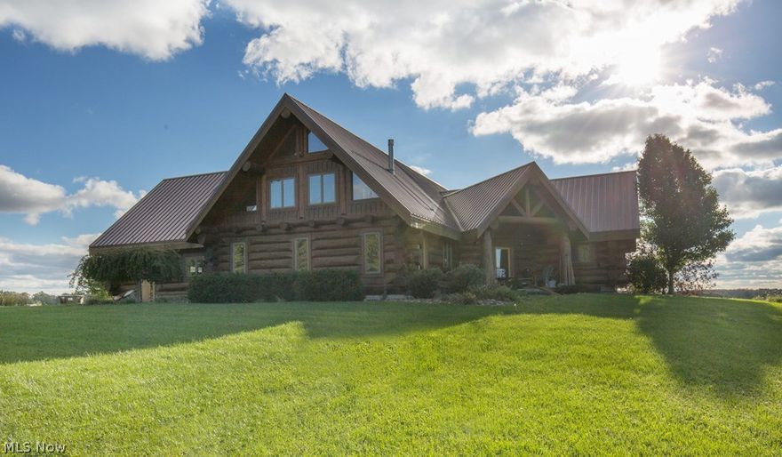 Amazing Opportunity - Spectacular Custom Hand Hued Log Home created in British Columbia using Western Red Cedar & Douglas Fir - Reassembled on a Fabulous Hill Side Site with Panoramic Views For Miles and a 5 Acre Stocked Lake on 25 Acres with & an Amazing 20 x 40 Outbuilding.  This Magnificent 3 Bedroom Log Home offers a Huge Open Great Room with Cathedral Ceilings & Wood Fireplace, Awesome Open Kitchen with Center Island, Tin Backsplash & Stainless Steel Appliances, Huge Master Bedroom with Fireplace, Awesome Walk In Closet & Large Master Bath with Floor to Ceiling Tile Shower & Fireplace, 2 other Bedrooms, 2nd Full Bath, Half Bath, Spectacular 2nd Floor Loft Area, & Amazing 2500 Square Foot Basement.   Home sits at one of the Highest Points in Mahoning County where your Scenic View is for Miles.  This home was Designed for Entertaining - with a Huge Cathedral Ceiling great Room.  Wall are made of Western Red  Cedar.  Douglas Cedar Beams.  4-5 Acre Lake.