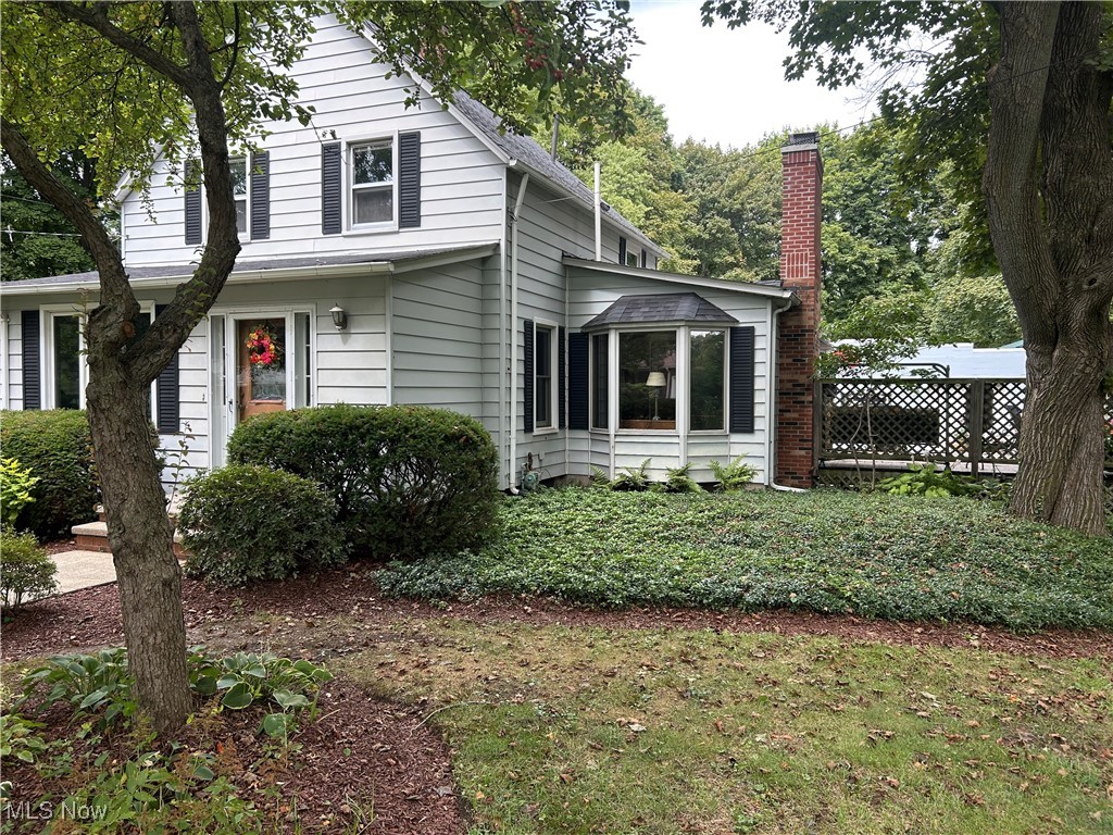 This beautiful Century Home is absolutely loaded with charm & character. It has all kinds of awesome built-in's and has a great first floor layout for entertaining. The Gourmet Kitchen was well thought out and would set up well for those who love to cook, or watch. The cozy living room features a brick fireplace and is located off the kitchen and surrounded by a home office and the two tiered deck. The family room and dining room both feature built in bookcases and display cabinets and old school woodworking and hardwood floors. The massive garage measures 40' x 50' and has room for 4 or 5 cars, also a work shop and a storage room and man cave. This also has it's own patio area and surrounded by an awesome display of flowers and butterfly bushes. This is a great place to relax after working in the large garden located just behind the garage. This is truly a place you will be proud to call home, as the current owners have for 45 years. Property is on just over 1 acre and the owners are separately selling adjacent lot 92' x 385'. see MLS #5156332