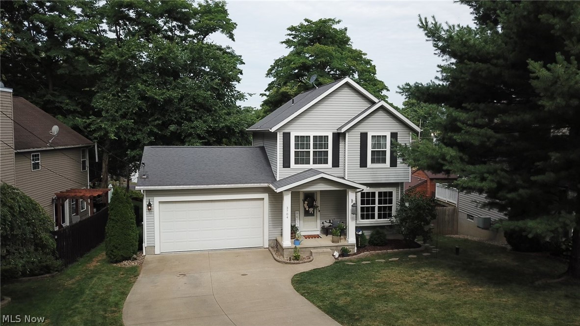Classic Colonial in the heart of the Portage Lakes! Just a short walk to the lakeside restaurants. From the front door you are welcomed into the large living room which opens to the eat-in kitchen featuring sliders to the large deck. From the deck, you can enjoy views of the boats cruising the channel to and from the main chain of lakes. From the kitchen, a hallway leads to the first floor full bathroom and the attached 2 car (20 x 24) garage. The concrete driveway provides plenty of room for extra parking. The second floor features a large master bedroom with walk-in closet, a full bathroom and 2 additional bedrooms. The walk-out lower level features a slider to the backyard and has been plumbed for a full bath. The neutral decor and excellent care make this home a real pleasure to tour. The seller is also offering a one-year home warranty! Call your Realtor today!