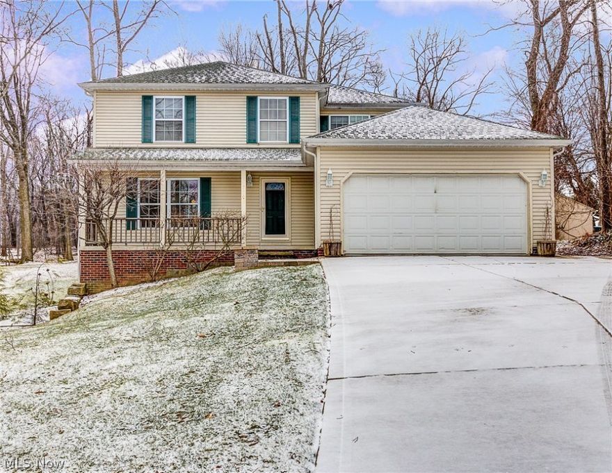 This center hall colonial features four bedrooms and two full and one half bath.  The walk-out basement is finished with a recreation and work area.  Walks out to the beautiful .69 acre park like lot with ravine and many trees.  Home has two car attached garage as well as another insulated garage at the back of the property.