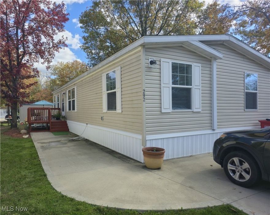 Welcome home to this well-maintained 4 bedroom, 2 full bathrooms manufactured home offering comfort, convenience, and modern charm. Built in 2020, this home features double parking right out front and a deck porch that warmly welcomes you inside. Step into a spacious 20' x 11' living room with an open-concept layout flowing seamlessly into the kitchen and dining areas—perfect for both everyday living and entertaining. The galley-style kitchen is a standout with beautiful wood cabinetry, ample counter space, and extra outlets, ideal for hosting. The bar-height island adds casual dining or extra prep space, and all appliances stay with the home! Just off the kitchen, you'll find a convenient laundry area, keeping everything within reach. The primary suite is a true retreat, measuring 14' x 11', with an in-suite bathroom. Three additional bedrooms offer flexible space for family, guests, or a home office. There is even an outdoor shed offering additional storage. This home combines thoughtful design with modern features. Don’t miss your chance to make it yours! Children can go to Firelands School District on open enrollment if desired.