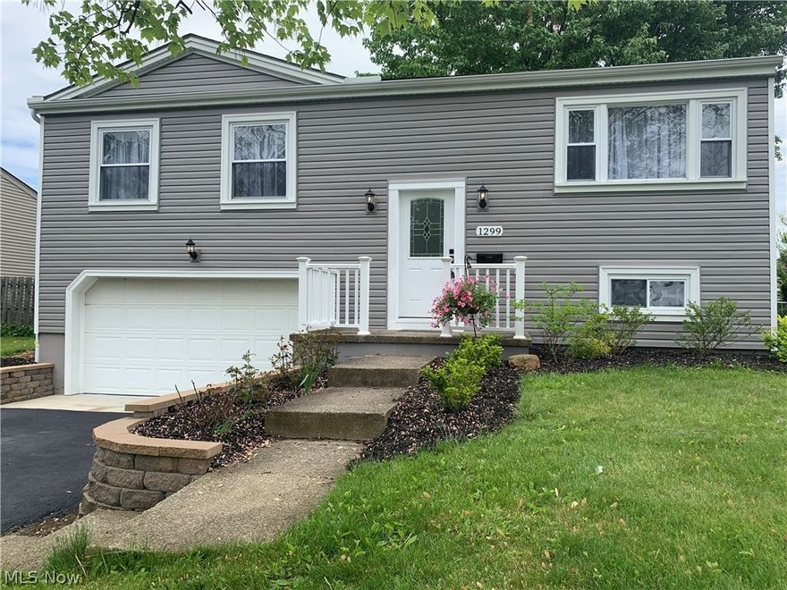 If you have been waiting for a beautifully remodeled home within walking distance of Austintown Schools this is it! As you come up the driveway take note of the new vinyl siding, gutters and downspouts, and great landscaping leading up to the porch. Once inside, you will see new carpet on the stairs leading you to refinished hardwood floors that shine in the living room all the way through to the bedrooms! The remodeled kitchen features tile and backsplash, with new appliances and a great amount of cabinet and counter space! French style doors in the dining area leads you out onto the new deck and take a look at a great sized yard almost completely fenced in. Finishing off the main floor is three good sized bedrooms with all new doors and an updated bathroom. Downstairs you will find all new laminate flooring in the family room with a nice sized bonus room to create any space you have been waiting to enjoy! A full bath has been added to the utility room, with a modern industrial ceilin