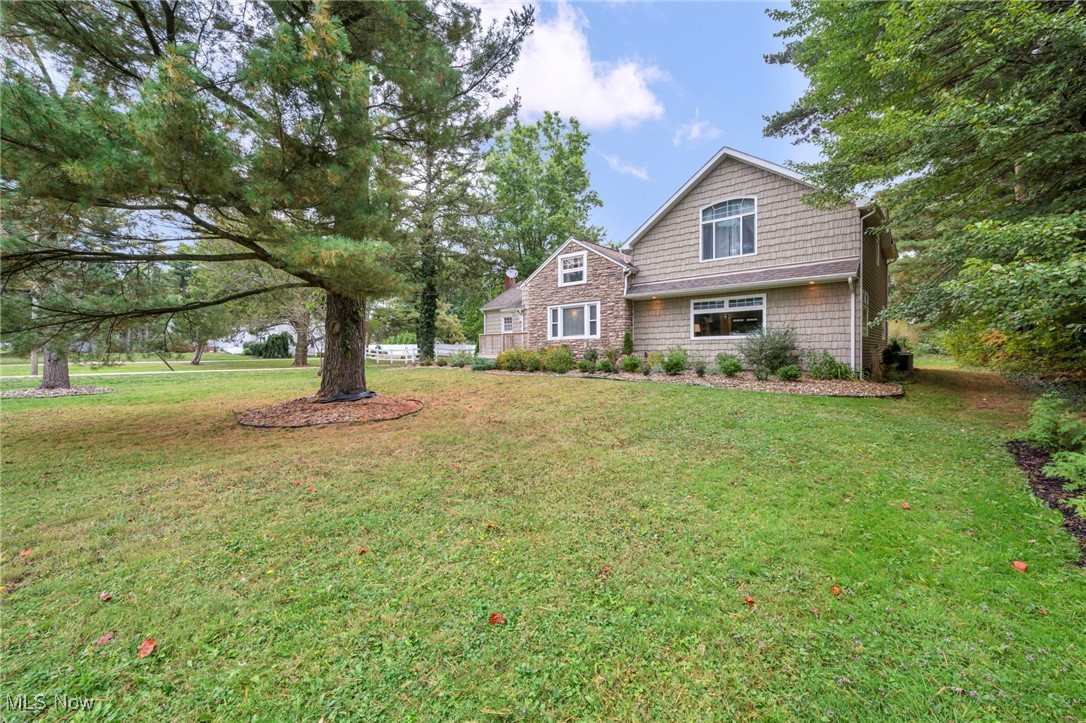 Spacious and full of character, this 3-bedroom, 3-bath home offers nearly 3,000 sq. ft. of living space on a private 1.26-acre lot. The fully updated eat in kitchen features slate flooring, granite countertops, and stainless-steel appliances. If you are looking for more formal dining, the dining room has a gas fireplace to set the mood. The primary suite features a built-in desk, large walk-in closet, spa-like jetted soaking tub, and access to a private wood balcony for morning coffee or evening relaxation. The large deck and patio extend the living space outdoors, perfect for entertaining or enjoying the peaceful setting. The lower level includes Nature Stone flooring and a convenient laundry area complete with a handy laundry chute to help "lighten the load". A highlight of the property is the oversized detached two-car garage with a fully finished loft space, ideal for a home office, studio, or guest retreat. The garage is heated, air-conditioned, and includes a half bath. A dedicated painting room with exhaust fan adds even more versatility to this unique space. Located just minutes from the YMCA, Macedonia Family Recreation Club, shopping, dining and highway access this property combines modern updates, functional spaces, and a convenient location.