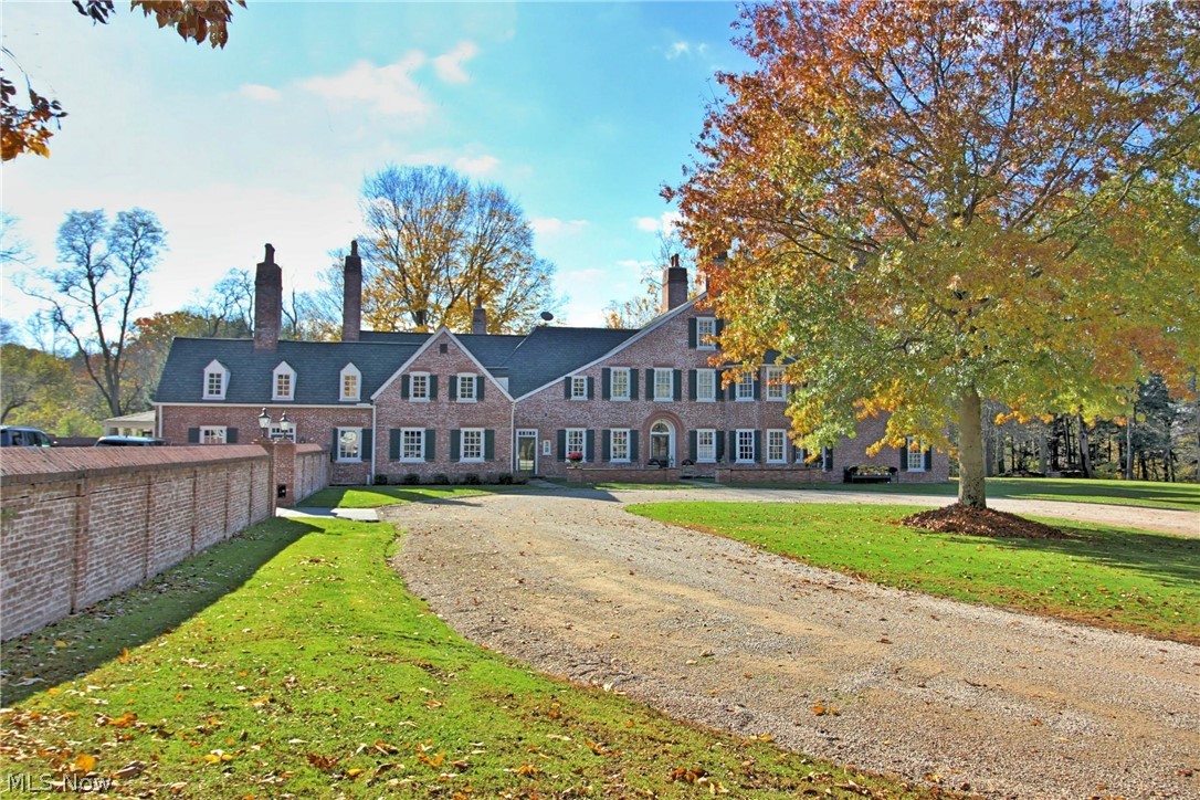 One of the grandest homes in Northeast Ohio! This late 1920s estate is sited on 8.5 breathtaking acres and backs up to the Bishop Preserve with 120 acres of woods, trails and ravines. This unbelievable property has a scenic private drive to Fairmount Boulevard winding up along the Chagrin River that includes the historic George Brown bridges. This storied home was originally built for Samuel Mather's daughter as a wedding gift! Grand foyer with a sweeping staircase and fireplace graciously welcomes you to this well-preserved and tastefully updated home. 15 fireplaces! The kitchen has left us speechless! Truly a chef’s dream with soaring ceilings, a huge center island, the best appliances available, beverage bar, and a hearth room making this the cozy heart of the home. We’re not kidding, it’s right out of a magazine! A banquet-sized dining room, ideal for your fancy dinner parties. His & her libraries, and an elegant living room. Outdoor stone patios, inground pool with a covered pool house, huge 6 car garage-ideal for a car enthusiast. And so much more—it is simply stunning!