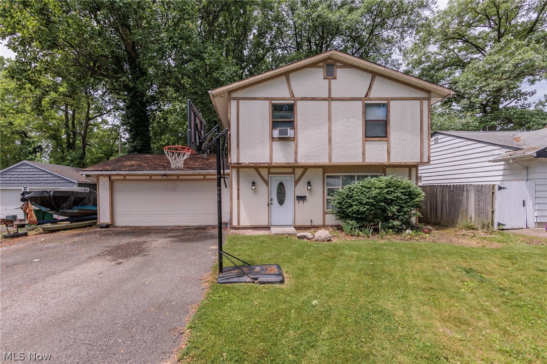 Outstanding opportunity to have a 3 bedroom, 1.5 bath Colonial style property with fenced in backyard situated on 2 lots in Mentor. Property is in need of some TLC and is being sold AS-IS. First floor offers large living room with bay style front window, coat closet, oversized eat in kitchen equipped with much cabinet space and stainless/black appliances. Utility/laundry room (washer/dryer excluded), half bathroom, and access to attached 2 car garage with door to rear fenced in yard/shed. Second floor offers full bathroom with tub, 3 bedrooms and ample closet space. This is perfect for someone that is looking to obtain a great property with much potential at a great price and that also does not mind putting in a little work. Plenty of parking space with this double wide sized driveway. Roof needs replaced, soffits need attention, some exterior rear yard clean up would spruce up the outside. This place is ready for its next homeowner to give it a fresh look!