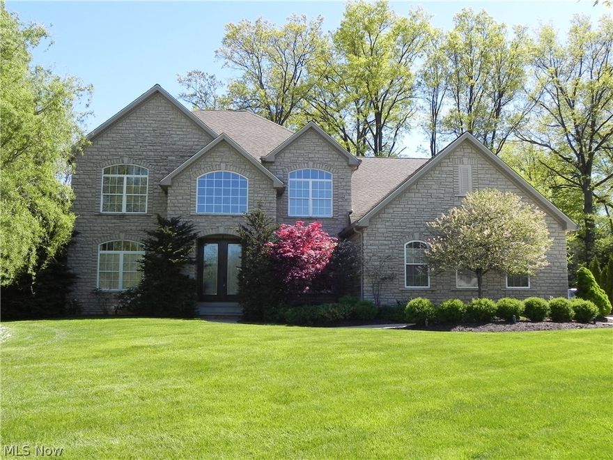 This exceptional home offers 3257 SF of unique custom features and upgrades, few others on the market can compare! The Formal dining rm is well-lit with tray ceiling, wainscoting and crown moldings. Upgraded windows and treatments throughout the home including plantation shutters and Hunter Douglas auto close blinds. Upgraded groumet kitchen ~ wine cooler, custom island, granite counters. 5 full baths on 3 levels with upgrades in many including 1st fl full bath with office access.  Master closets are sizable!  Just 1 of 2 closets is 15x11.  Master bath offers several custom features as well.  Finished bsmt with home theatre system plus equally large unfinished storage area.  Security system includes 8 cameras, phone/computer access and entry sensors.  All appliances can stay, solid composite wood interior doors throughout, main fl oak flooring and arched openings throughout, 1st fl office.  Garage is a dream! Heated, well-lit, full of conveniences including drain, hot/cold utility sink