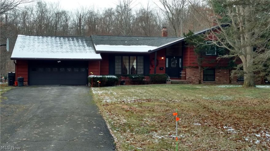Location, spacious, enclosed porch, walk-out family room, and almost one acre of peaceful! BEST words to describe this 3 bedroom, 2 1/2 bath split. This home is ready for your personal palette of color, placement of your favorite pieces of furniture, art and a call to your favorite landscaper for the perfect design for this wooded private lot.The vaulted foyer opens to the living room, dining room(with new carpeting in 2018) and flows in to the eat-in kitchen.Updates to the kitchen include new floor, backsplash, newer appliances, Corian countertop and sink. A slider door in the kitchen takes you to the enclosed porch that steps down to the backyard.The second level master bedroom has an en-suite bath with walk-in shower, two additional bedrooms with great closet space and main bathroom. And YES, there is a clothes shoot.The lower level family room features a brick wood burning fireplace with heat insert, 1/2 bath, laundry room and the walk-out to the backyard. The extra large two car g