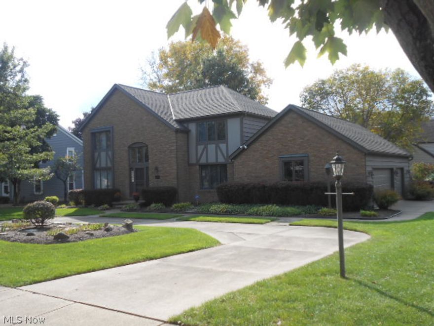 This impressive Tudor style Colonial is situated on a beautiful 1/2 acre lot and was custom built with quality throughout.  Step into the dramatic 2 story foyer with oversized 2nd floor window and a  curved oak stairway.  Formal living and formal dining rooms with crown molding.  1st floor bedroom or office  with a  full bath!  Huge eat in kitchen with skylight, breakfast bar, walk-in pantry, desk, beautiful wood cabinets, corian counters and stainless appliances! Cozy family room with bar and gas fireplace.  Breezy 18 x 15 screen room overlooks a deck porch  and  beautiful private backyard.  The second floor has 4 more bedrooms plus a laundry room! Spectacular master suite with dressing area and 2 walk-in closets.  New roof in '05.  3 car garage.