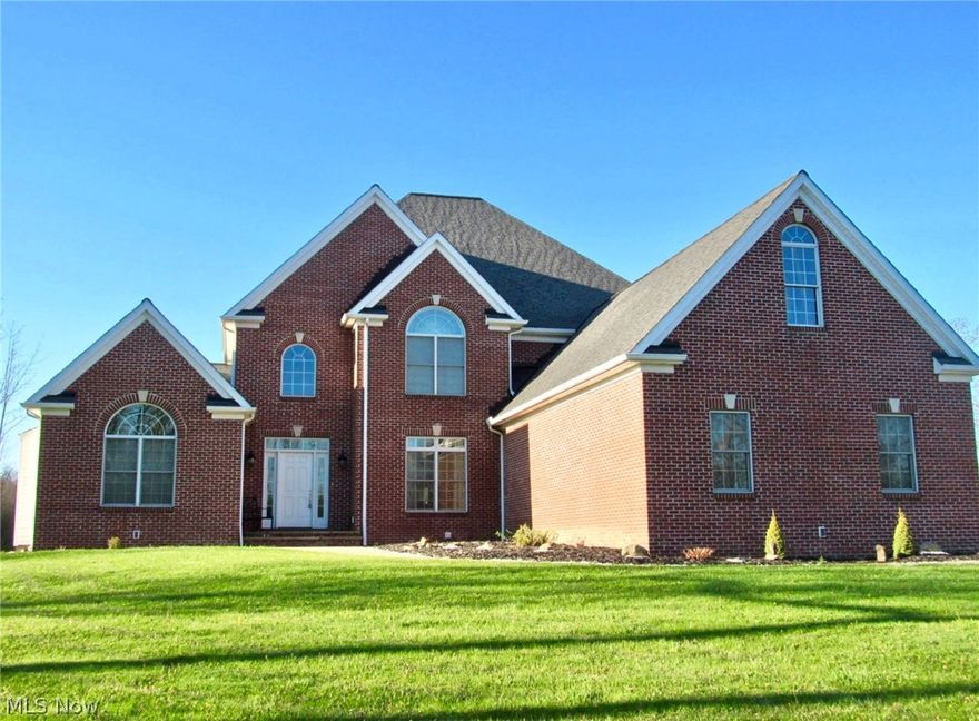 Privately set off the road this stately, beautifully maintained 5 BD, 5 1/2 BA brick front colonial sits on a 3.96 Acre flag style lot, the front entrance brings you to the 2-story foyer with rod iron open staircase and gleaming Brazilian hardwood flooring, formal dining room plus extra living area off of the well appointed kitchen offering island, breakfast bar, granite, octagon eat area, serving area w/ flat screen hookup, walk in pantry & appliances, 1st floor laundry rm w/slate flooring, granite plus washer/dryer, first floor powder room, 2 story, 18' high great room with stone, gas fireplace, wall of windows plus double fans & new carpet in 2020, 1st floor master suite with French doors to a private retreat sitting rm/office with gas fireplace, master bath with jetted tub, granite & double sinks, 2 walk-in closets, bedrooms upstairs offer full baths, spacious, carpeted loft perfect for game rm or media, large 13 course finished basement (in 2016) with full bath, bedroom #5 and div