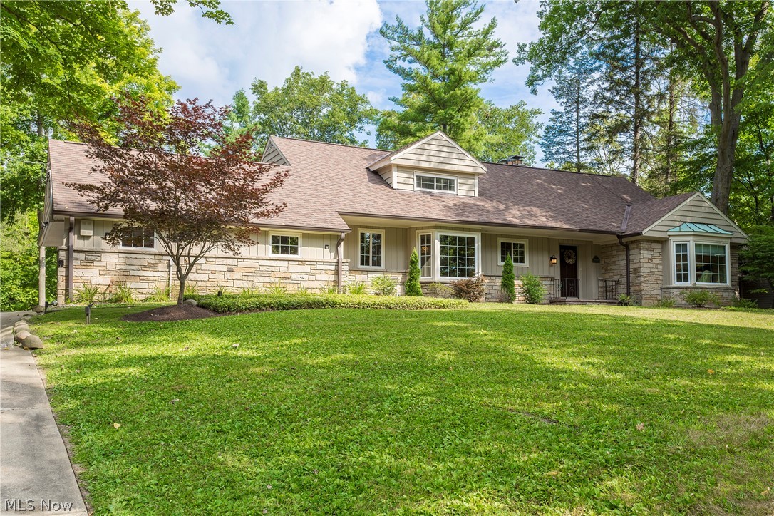 Welcome home to this beautifully renovated cape cod on a serene 1.5-acre lot in Pepper Pike! This delightful home is move in ready with everything you need, including a remodeled kitchen, an elegant master bedroom suite, and a gorgeous back deck. It is just waiting for a new owner. As you step inside, gleaming hardwood floors lead you from the welcoming foyer into the spacious living room, which features a wall of windows and an impressive stone fireplace. The step down living room is open to the family room, great for entertaining friends or just relaxing with family. The updated kitchen features granite counters, stainless steel appliances, and a sunny eat-in area. The first-floor master bedroom suite includes a private sitting area, a gorgeous bedroom with a tray ceiling, a vaulted travertine bathroom, and a spacious walk-in closet. Two additional bedrooms, an updated full bathroom, a laundry room, and two half baths complete the main level. Upstairs, you will find two large bedroom