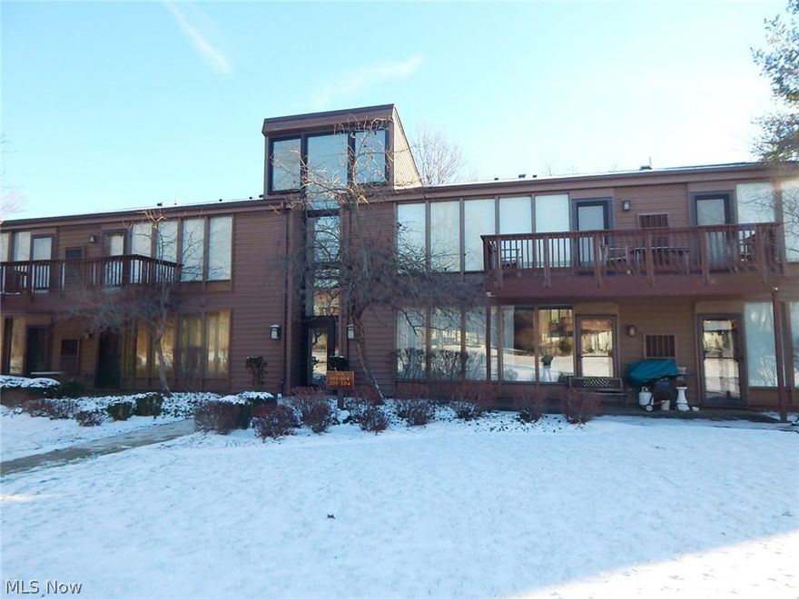 Pristine condo offers neutral décor, completely updated kitchen and bath with Corian counter tops and beautiful maple cabinets. The master bedroom has a walk-in closet and treed views with access to the covered porch. The den was a second bedroom but was converted to utilize the space better. The living room and dining room offer a wall of glass with views of trees and a slope that gives privacy. All appliances will remain including a stacked washer and dryer in the utility closet off the kitchen. There is also a detached covered garage space. This is a must see!