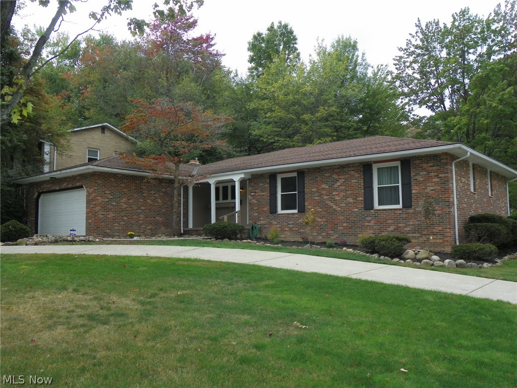 Large Brick Ranch on a corner lot in a nice development ! Circular driveway * Newer windows throughout * 3 nice sized Bedrooms with hardwood floors * 2 full Baths * Large Eat in Kitchen with Stainless Steel appliances and ceramic tile flooring * Open Living Room/Dining Room combo * Family Room with WBFP and slider to patio area * Master Bedroom has it's own updated Full Bath with a stall shower * Bedrooms have large closets * Nature stone garage floor * Freshly painted * Basement has glass block windows * Gas grill * Security system * Must see this wonderful home !