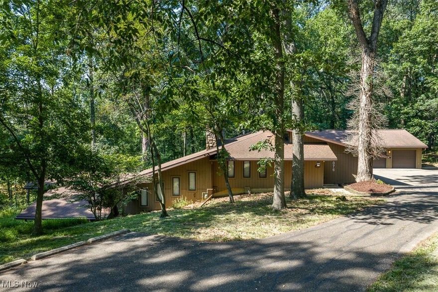 One of a kind, custom home on scenic 9+/- acre private retreat.  Quality built with 3 bedroom and 4 full baths.  Entry foyer with ceramic tile floors.  Natural sunlight fills the spacious formal dining room through the triple sliding glass doors leading to the deck. The living room also boasts beamed wide plank pine ceilings and stone woodburning fireplace.  Hardwood floors in the beautiful white Schrock kitchen with Corian counters, walk in pantry sub zero double fridge and cathedral ceilings with glass gable.  The island breakfast bar in the kitchen features butcher block counters and sink.  Stone fireplace in the dining room with gas hook-up.  Full bath on the main level features walk in tile and cultured marble shower.  Cathedral ceilings in the relaxing sun room with glass doors to the deck.  The family room makes an excellent gathering place with cathedral ceilings and corner stone gas fireplace.  The lower level includes a library and cozy rec room with stone woodburning fireplace.  The master suite with private access to the backyard also boasts his and hers walk in closets and a full bath with double sinks, sunken whirlpool tub and separate shower.  6 car attached garage and additional 4 car attached garage with separate furnace and air units.  Many upgrades throughout including new roof in 2020+/-. leaf guards, 82 gallon hot water heater, and Pella windows throughout.  Beautiful country setting with 9+/- acres providing scenic views year round!  Convenient location with a country feel, just minutes to Crater Stadium and downtown.  Home includes valuable timber and mineral rights owned by the seller will transfer.  You will not want to miss this one.  Taxes reflect the seller receiving a homestead credit of $397.24 annually.