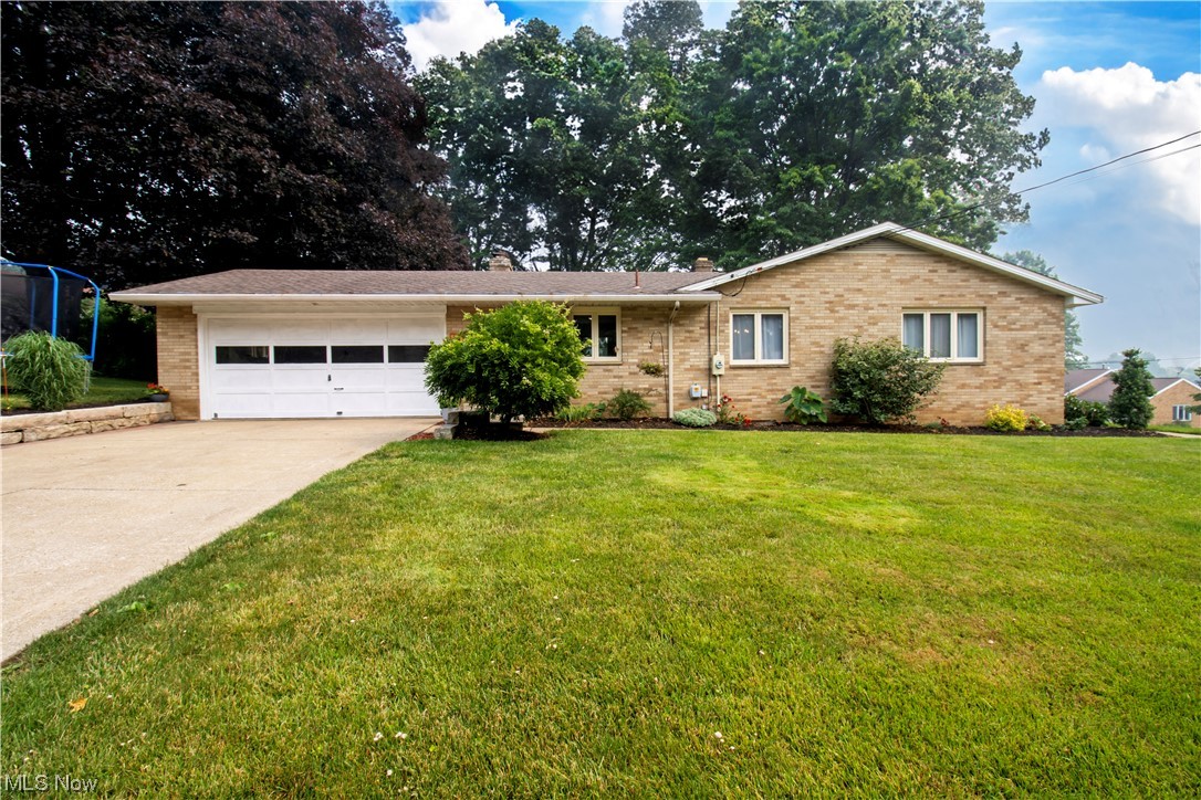 Absolutely adorable brick ranch in an established Wooster City neighborhood that offers both charm and many cosmetic updates. Situated on a corner lot, you'll appreciate the outdoor space with patio option or fire pit with a park like grill plumbed with gas. From the two car garage you enter into the open concept, fully applianced kitchen area with solid wood cabinets and inviting sitting area with wood burning fireplace. Sellers use this cozy space a lot and particularly love it when a fire is going! Everything has been repainted with updated fixtures and new trim added throughout. This home gives an updated feel with a nod to the past with the original hardwood floors in all bedrooms. The formal dining space with black ceiling gives a very modern, moody vibe while the bright updated main bathroom and accent features behind the built in shelves and sink is fun and almost whimsical. Central air will keep you cool in the heat of summer and has been recently replaced n 2020 along with th