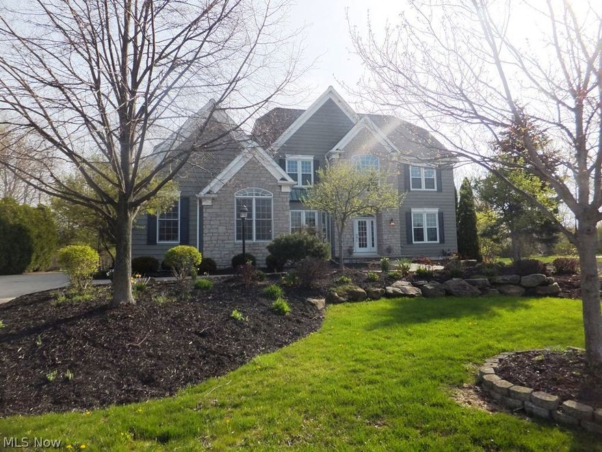 Spectacular former model home with more than $100,000 in updates over the past year! This spacious home has 4 bedrooms, 4.5 baths and more than 4,200 sq. ft. of living space. The 10 ft. ceilings with columns and custom trim add to the open, airy feel. Any gourmet chef would love the kitchen featuring new granite counters and all appliances. A beautiful stone fireplace highlights the family room, while another see-through fireplace can be enjoyed from both the master bedroom and bath. All of the bedrooms include walk-in closets, and each bath has new granite counters. The finished lower level offers an enormous recreation area, a guest suite including full bath, an office with built-ins and more. Enjoy the newly landscaped yard from the 2-tiered deck or new patio. You'll also appreciate the new high efficiency furnace and air conditioner as well as the heated 3-car garage. Freshly painted and carpeted throughout, this home is an absolute must see!