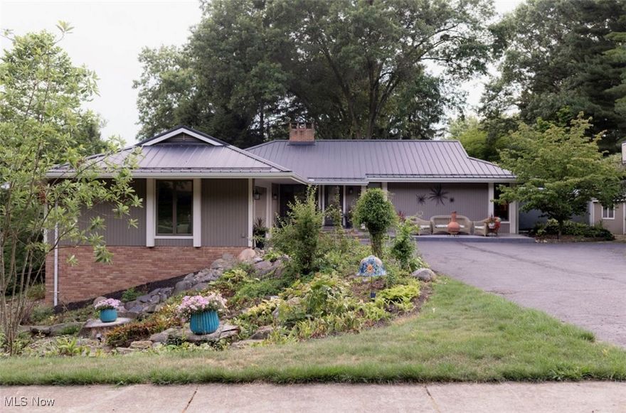 This amazing ranch home with its fabulous curb appeal, nestled in the middle of its's own private park, boasts four exclusive outdoor seating areas. Each area offers a different perspective of the gorgeous landscape. The stone steps, walkways and solar lighting add to the upscale feel to this property. The quaint greenhouse/shed that is tucked at the end of a flower lined stone walkway is perfect for your lawn tractor or your favorite golf cart. This property is in close proximity to the Country Club. The upper deck of the home has a remote Sunsetter awning that protects your outdoor dining from the elements. The lower patio area has a hot tub steps outside the walkout basement door and offers additional seating overlooking the variety of plantings. A door was installed from the owners suite to the new pergola that is outfitted with furniture, gas firepit, outdoor heater and tv connections making it the perfect private getaway. The owners have added extensive updates too numerous to list here, to the home. From the metal roof to new solid doors, hardware and woodwork, can lighting and fans, updated flooring, new bathrooms, granite counters and new backslash in the kitchen. The home was converted from all electric to all gas. As you step in the front door you will feel the embrace of a warm welcome. You will be drawn to the tall Anderson Casement windows where the beautiful park setting meets the comfortable 1650 square feet of space on the first floor and the equally appealing 1600+ finished square feet of the lower level. The LL boasts the fourth and fifth bedrooms with egress windows, an updated full bath, a gas fireplace and a walk out door to the patio. This home has awesome curb appeal, landscape that will make you the envy of the neighborhood and a turn key interior. Don't wait a minute to call for your private showing!