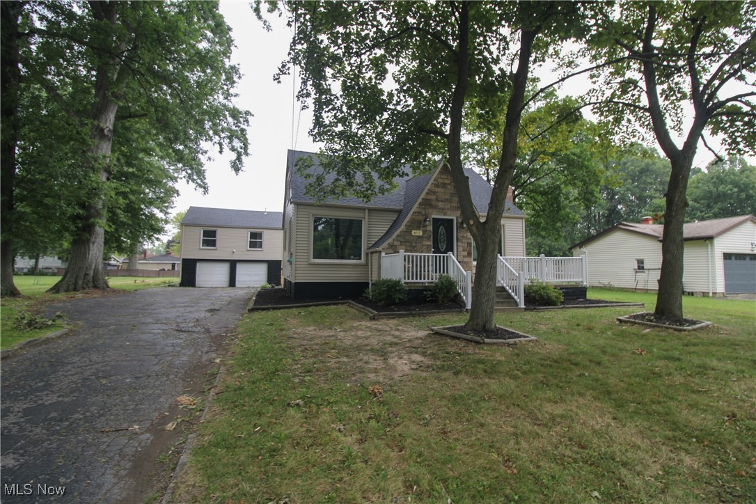 Welcome to this charming Cape Cod home nestled on an half acre of property in Austintown, Ohio. Heading to the front door you'll be greeted by a spacious front porch, perfect for enjoying quiet mornings or evening sunsets. Inside to the foyer, where you'll find a convenient area to remove shoes, along with a coat closet for added storage. The home boasts a large living room complete with a cozy fireplace, offering a warm and inviting space to relax. Both the living and dining room feature large picture windows that flood the space with natural light. The first floor includes a bedroom and a full bath, providing convenience and accessibility. The kitchen is equipped with appliances, and offers ample space for cooking. Upstairs, you'll find two additional bedrooms, perfect for family or guests. This home has been thoughtfully updated with new flooring throughout and has been freshly painted, giving it a modern and clean feel. The basement has been professionally waterproofed, and glass block windows are scheduled to be installed next week. Additionally, the home features a new roof. Outside, you'll discover a back patio, ideal for outdoor gatherings, and a detached two-car garage with its own sump pump. Above the garage is a charming one-bedroom apartment, complete with a kitchen, living room, and full bath. This apartment has also been freshly painted and updated with new flooring, and it includes a new hot water tank. This property offers a unique blend of comfort, convenience, and the additional apartment, making it an excellent opportunity for whatever you see fit!