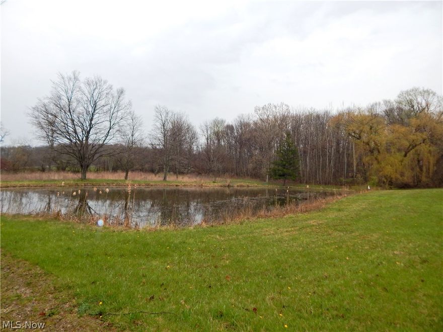 Secluded lot located off the road.  Long driveway to lot.  Utilities are available. Water utilities are on property.  Pond and wooded. Flat area if you are looking to build.