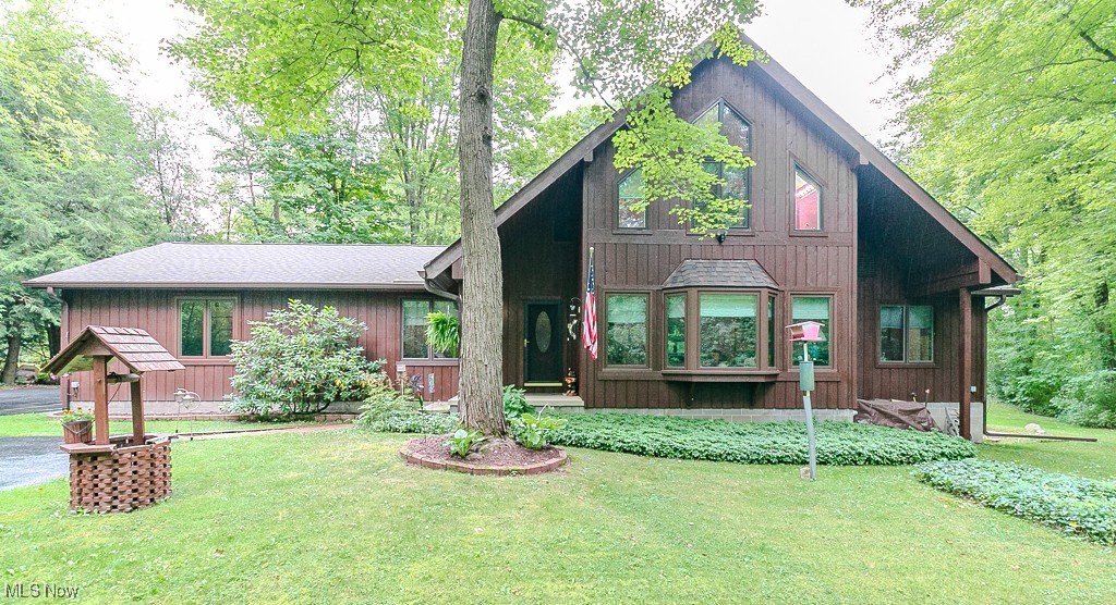 A nicely paved driveway, leads back to this charming 1.5 story, A-frame-style home, with cabin-appeal, yet traditional inside! If you desire more land, here is 4.53 acres to call your own, surrounded by trees, front & back! Stand at your front door, and enjoy the precious creek flowing along, enhancing the joy of owning this lovely home! Sitting on your beautiful deck, you'll enjoy the park-like privacy this property exudes! Entering this cozy abode, you'll see a large, accommodating space, being used for both living rm & a fam room, with gas fireplace. Having two bdrms., a full bath and a half, and a dedicated laundry room on the main, is a plus! Farther into the house, you’ll find a beautiful dining room, able to accommodate a large table for special occasions! You'll also have the practicality of an eat-in kitchen, with all the cabinets you'll need, along with a helpful pantry for food storage, and more. This kitchen boasts marble counter tops, granite sinks, and a garden window, a few of your plants will enjoy. All appliances stay, along w a freezer in the bsmnt. Now for the surprise, winding staircase leading to the primary bdrm., on the 2nd floor! Nothing like having a home, unique from all the others! This large bdrm., has a fireplace, vaulted ceilings, skylights, & a small deck. The en-suite bath offers both a refreshing shower, or a long soak in your own whirlpool tub and nice large windows bring in great light! Wrapping up, this home has a full sized (walk-out) bsmnt., & carpeted area in the back, once used for a small business. The 2.5 attached garage is all you'll need! The cedar siding has been recently stained, & a NEW roof offers its owner peace of mind. De-Ice Panels help to achieve no ice build up at gutters. Water going from well to boiler, is energy efficient, gives consistent even heat, better indoor air quality, w hot water on demand! Don't wait, get your offer in now!