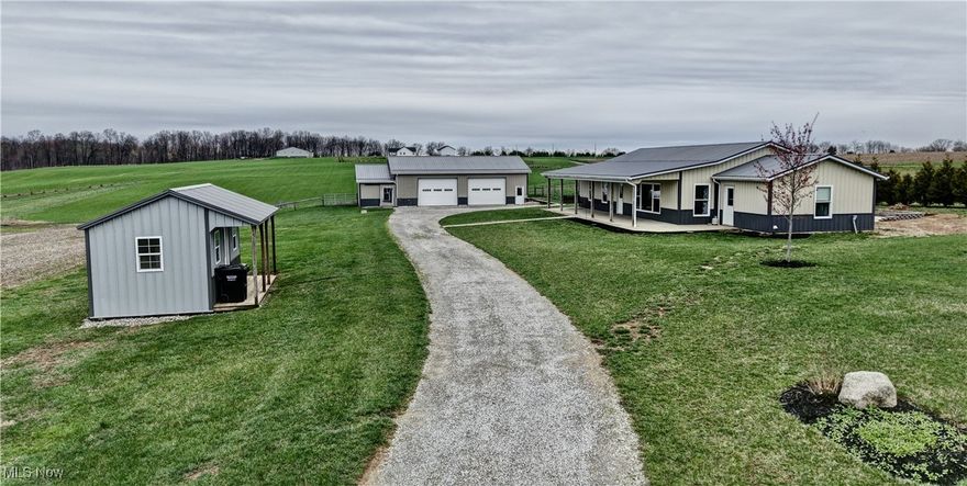 Nestled just 15 minutes from both Mohican State Park and Pleasant Valley Lake, and only 20 minutes from Wooster, this 9.59-acre property offers the perfect blend of peaceful rural living with convenient access to local attractions. Built in 2016, the 1,740 sq. ft. home features an open floor plan highlighted by a warm hickory kitchen, a welcoming dining area, and a comfortable living room. With three bedrooms and a full bath, there’s plenty of space for family or guests. A practical mudroom off the kitchen includes laundry facilities, adding convenience to daily living. Step outside to enjoy a spacious concrete patio complete with a firepit—ideal for relaxing evenings or entertaining. The impressive 48' x 32' detached garage includes a 10' addition currently used as a barn, and a 16' x 10' shed provides even more storage space. The land features open hayfield and pasture areas, perfect for hobby farming, gardening, or simply enjoying the outdoors. Whether you're searching for a mini farm, a starter home, a peaceful retirement spot, or a weekend retreat—this property checks all the boxes.