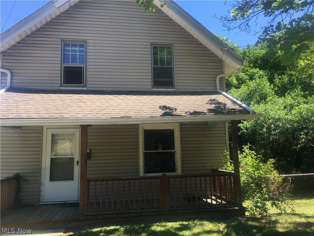Spacious single family home on a corner lot with a fenced in yard. The covered front porch leads into a spacious living room and dining area with the original wood trim, built ins, and a fake brick fireplace. The kitchen is equipped with stove and refrigerator. The upstairs has three bedrooms with new carpet and a full bath with shower, nice closet, and a new vanity. There is an unfinished basement with a walk out door that leads to the driveway an fenced in yard.