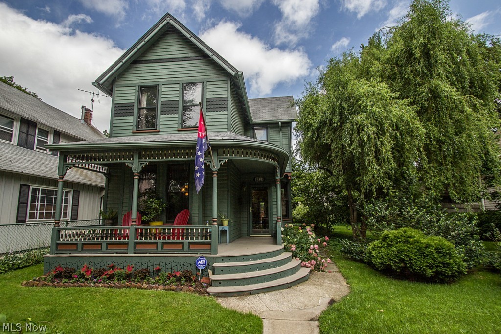 Welcome to this 1880's Victorian on tree-lined Whitman Avenue in Beautiful Ohio City. Situated on one of the Premier streets in the neighborhood, this home sits on a rare double lot, providing you with the perfect urban oasis. From the moment you walk up, you'll notice the detailed spindles and curved wrap-around front porch surrounded by the blooming hydrangea hedge. As you enter this move in ready home, you'll notice all the original details including decorative fireplace and hardwood floors and trim. The open layout is conducive to today's lifestyle while retaining the character and integrity of the home. No Ohio City renovation would be complete without an open and modern kitchen, featuring gorgeous granite countertops, stainless steel appliances, plenty of cabinet space and vaulted ceilings. Upstairs you will find an open common area between the bedrooms, perfect for a home office. The bedrooms are bright and have easy to clean hardwood floors and large closets. The master bath wi