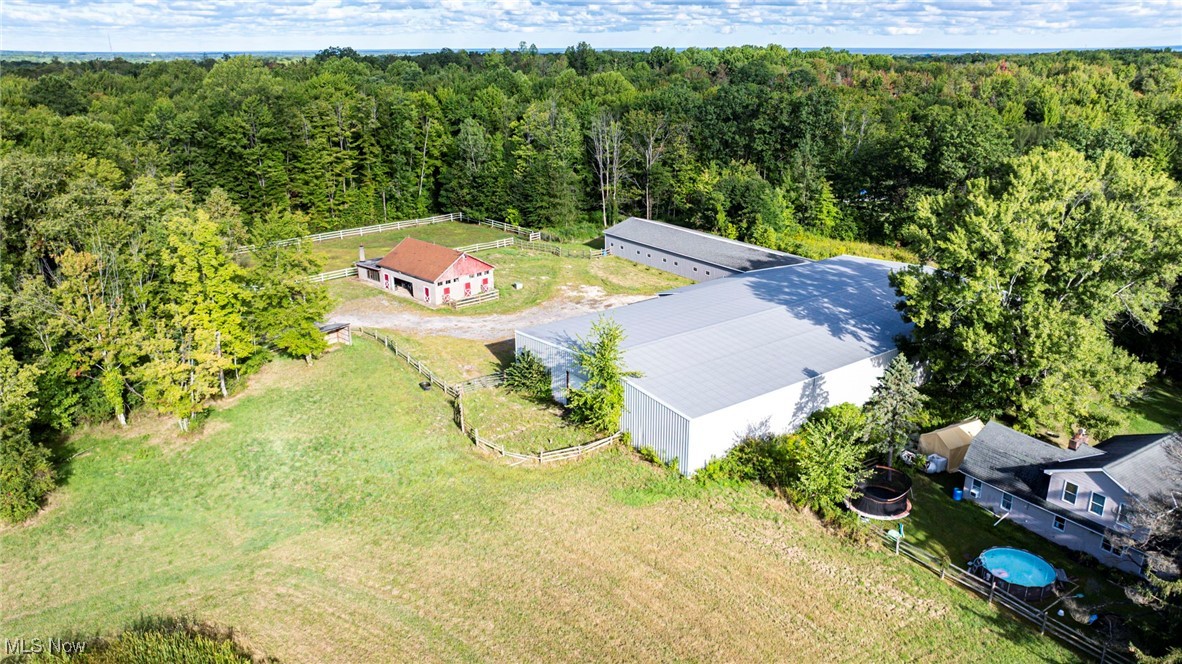 Equine Facility on 17+ Prime Acres! Your opportunity of a lifetime is waiting for you with 20 fully matted stalls, wash rack with hot water, viewing and tack rooms, separate feed, sawdust, and storage rooms. Hay loft with indoor stair access can store 500+ bales. Amish built 180 x 80 indoor riding arena with lifetime metal sided and roofed built in 2004. Outdoor arena 180 x 80 and fenced 4+ acre pasture with run in and pond, plenty of trailer parking and access to water. Bonus block building on site that has space for all the equipment and 600+ sq foot additional viewing/living area with a fireplace. 1 full and 1 half bath, and full kitchen potential. Behind facility there are 10+private park-like acres with running stream and trail rides or build your dream home! Upgrades include (2) hot water tanks, bathroom remodel, plumbing, fencing, security system, high speed internet, surround sound, lighting, and arena footing. This property has all the income potential to build a boarding or therapeutic riding facility while living your horse owning dreams. All this is conveniently located less than 2 minutes from I-90 ideal for boarding or training clients. Call today to see this amazing property and make your dreams come true!