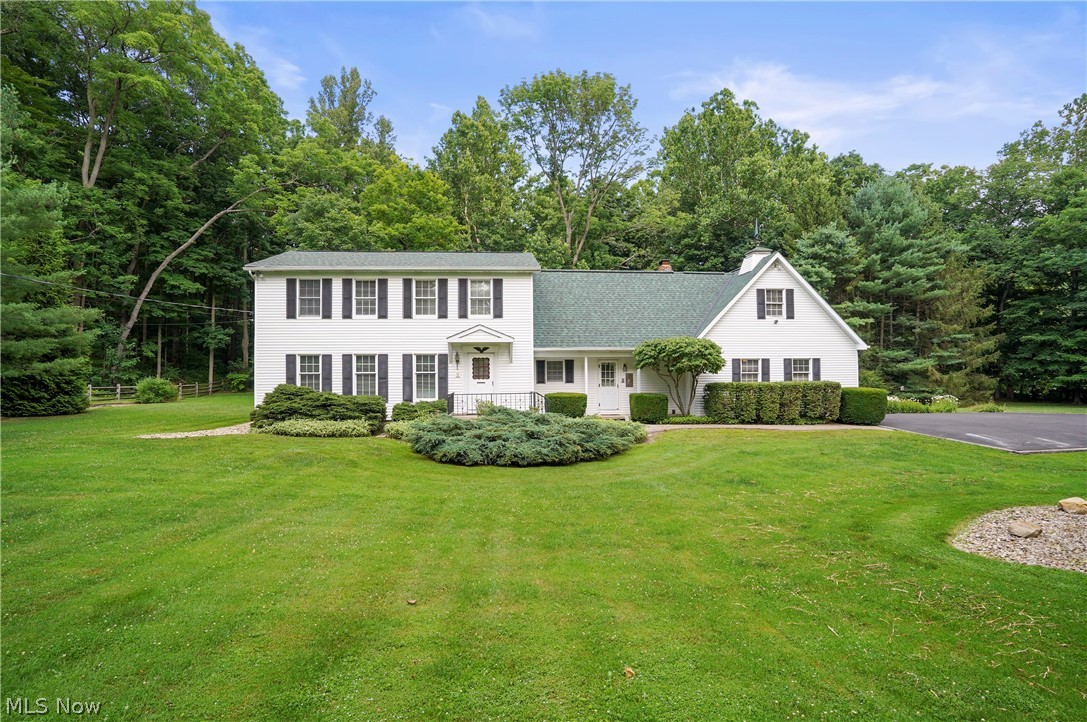 Over 4.5 beautiful acres in Kirtland boasting a one owner, well cared for home. The love and care of this home is evident as you pull into the oversized driveway with extra parking. You are surrounded by the landscaped yard with French drain, woods and a creek along the right border. Enter the 2-story foyer with parquet flooring connected to the Living Room with natural light, crown molding and plush carpeting. The formal dining room has a bay window, chair rail and built in china cabinet. Spacious Eat in Kitchen featuring oak cabinets, pantry, lots of counters, double wall ovens, all appliances, large eating space and brick arched chef's cook top alcove opens to the Family room. The Family room is accented by the Brick Wood Burning Fireplace, wood mantel, beamed ceiling and sliding doors to the enclosed porch. First floor Full bathroom with stall shower and first floor laundry room has washer and dryer, a slope sink and several storage options. Head upstairs to the Primary Bedroom featuring dual closets, private full bathroom with stall shower, ceramic flooring and amazing walk-in attic that offers opportunity to be finished. The three additional bedrooms are oversized with generous closet spaces located by the third full bathroom with large linen closet, and pocket door separating the shower from the sink area allowing for multiple use at the same time. Unfinished, waterproofed basement with sump pump can be finished to add even more living space, a workout room or perfect for a gaming area. Attached garage with newer garage door and opener, high efficiency Furnace and Central air 2 yrs old, HWT 5 yrs old, Full tear-off Roof 2 yrs old, Anderson double pane windows, and a newer Shed. The tranquility of the back yard with paver patio and enclosed sun porch, the wooded acreage and creek complete this beautiful property and meticulously cared for home.