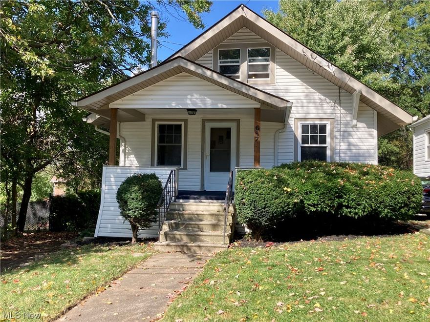 Welcome to 697 Iona Ave in Akron's historic Kenmore neighborhood.  This nice maintained, move in ready, 1 1/2 story bungalow is a charming property.  Enter through the front door and be greeted by original, refinished hardwood flooring in the gracious living room and as you enter the connected dining room.  The living room also provides a wood burning stove.  Turn into the spacious eat-in kitchen with plentiful storage and cooking preparation spaces.  The bathroom has had some recent updates including attractive laminate flooring, new title surround, and updated vanity.  The freshly carpeted bedrooms on the main floor are cozy and comfortable.  Upstairs is a spacious, open dormer bedroom or optional living space.  The basement provides plenty of utility storage space and laundry hookup.  The built-in/attached garage connects to the basement just to the right of the stairwell.  Outside a long paved drive offers plentiful off street parking and a comfortable backyard space for quiet nights at home or entertaining guests.  Additionally, the house has been outfitted with updated vinyl windows.  This house is ready to be your home, contact your agent today to set up your property showing.