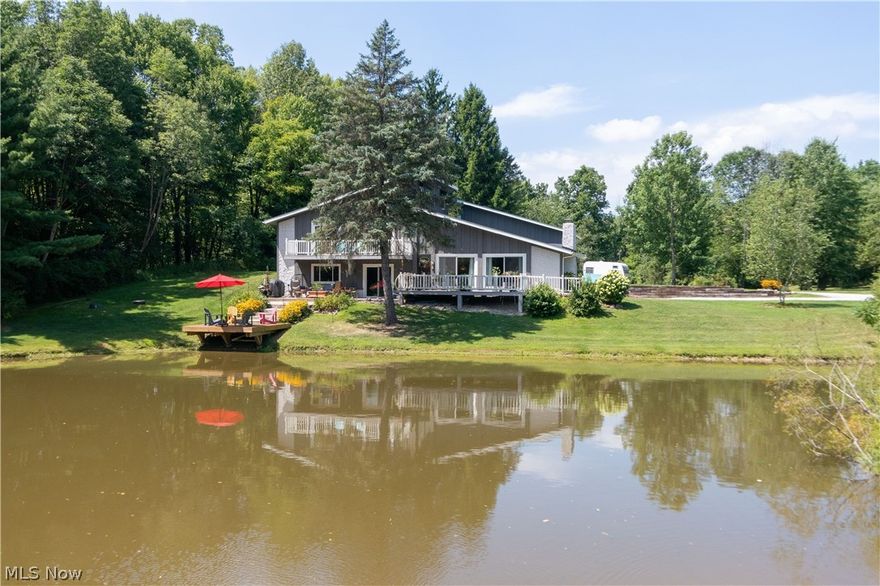 Updated Mid-Century beauty is located on an awesome, private & secluded property situated on 3 parcels and offers a metro park "like" feel.  This home sits on 8.75+ acres and includes a lake & pond.  Open floor plan is perfect for entertaining & offers spectacular views from every window!  The spacious living room features vaulted ceiling, wood beams, wood burning stone fireplace & is open to the kitchen and dining area.  The updated eat-in kitchen offers fantastic views of the lake and enjoy the sliders to your deck & patio to enjoy the seasons & wildlife. Convenient 1st floor laundry and 1st floor full bath!  The loft/bar area is super nice (pool table can convey) w/ french doors to a family room/full bath and bonus room, which could be an additional living suite since it has steps to outside.  The master bedroom features 2 sets of sliders to it's private deck & a 14 x 10 walk-in closet!  All 3 baths have been updated. 
The 40 x 32 outbuilding has concrete floor & electricity.  Many
