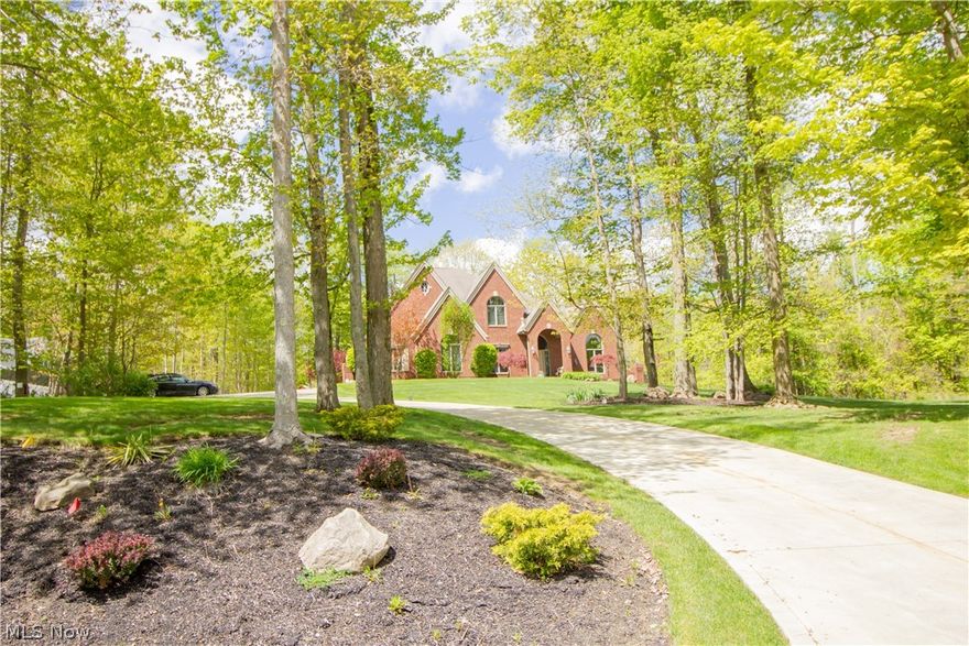 Meticulous / Quality Built Colonial with Brick Facade situated in a Beautiful Wooded Setting!  Pride of Ownership!  9' 1st Floor Ceilings;  Extra Wide Hallways;  Two-Story Foyer;  T-Shaped Staircase;  Open Living Room/Dining Room;  1st Floor Library/Office; Family Room with Fireplace (Wood or Gas). Many New Updates Throughout including Brand New Flooring, New Trim and Solid Doors!!!!  Dream Gourmet Kitchen with Huge Island, Granite Tops, Morning Room Eating Area, Newly Installed Custom Cabinetry, Upgraded Built Ins & Appliances!!!  11x8 Laundry Room with Barn Door;  Owner's Retreat with Feature Ceiling, Sitting Area, 2 Walk In Closets and Updated Private Bath with Granite Tops!!   Private Bath off Vaulted Guest Room;  Jack-n-Jill Bath Between Two Bedrooms!  Fully Finished Lower Level with Recreation Room, Fireplace, Wet Bar, Game Area and Workout Room!  This Home also Boasts a Heated In Ground Pool with Wrought Iron Fencing, Slide and Diving Board!!!  Sprinkling System;  Pet Stop Electric Fence;  3 Car Garage with New Epoxy Floors!  A New Concrete Driveway was installed 5 Years Ago with Added Additional Parking Areas!  Water Softener (4 Years old) Will Stay!  Geauga County Septic Inspection completed and in good working order!