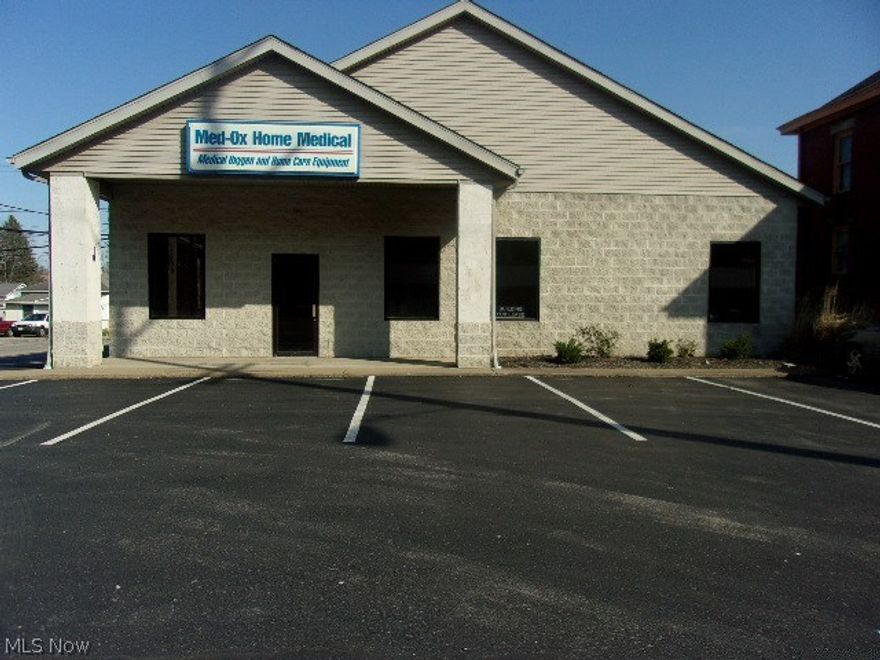 Great commercial location in the area of many successful businesses. Level lot. The building features a large garage area with two 10 ft. overhead doors and 12 ft ceilings. Office rooms, reception desk, storage area. Quality construction. Move-in ready. High visibility. A rare find!