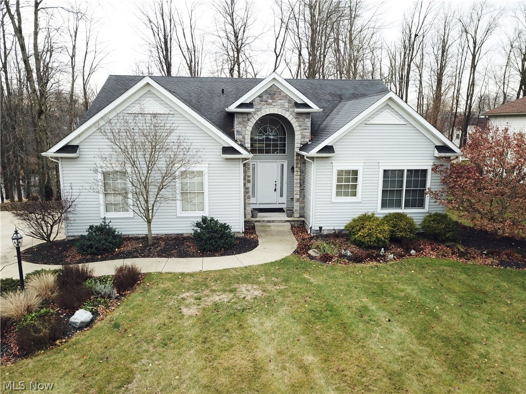 Gorgeous ranch located on quiet cul-de-sac in Mystic Pointe! If you're looking for a perfect size ranch with an open floor plan and unbelievable finished walk-out lower level then your search stops here! 3,500SF of finished living space- Just over 2,000SF on the main level including all 3 bedrooms and 2 full bathrooms, lower level adds about another 1,500SF of finished space with the 3rd full bathroom! Lower level boasts media room with projector and 108 inch Da-lite screen framed by paneled columns, tray ceiling with adjustable accent lighting, surround sound, built in display case, corner stone fireplace, pool table and wet bar with custom built-in wine rack! Main floor has a spacious open feel from the 10' wide foyer with vaulted ceiling which opens to the living room and kitchen with vaulted ceilings. Kitchen includes dining area and walks out to the deck across the back of the house. Master bedroom suite includes 2 walk-in closets, large open bathroom with dual vanities, garden tu